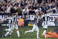 Juventus' Arturo Vidal (R) celebrates scoring a penalty during a Serie A match against Palermo on May 5, 2013